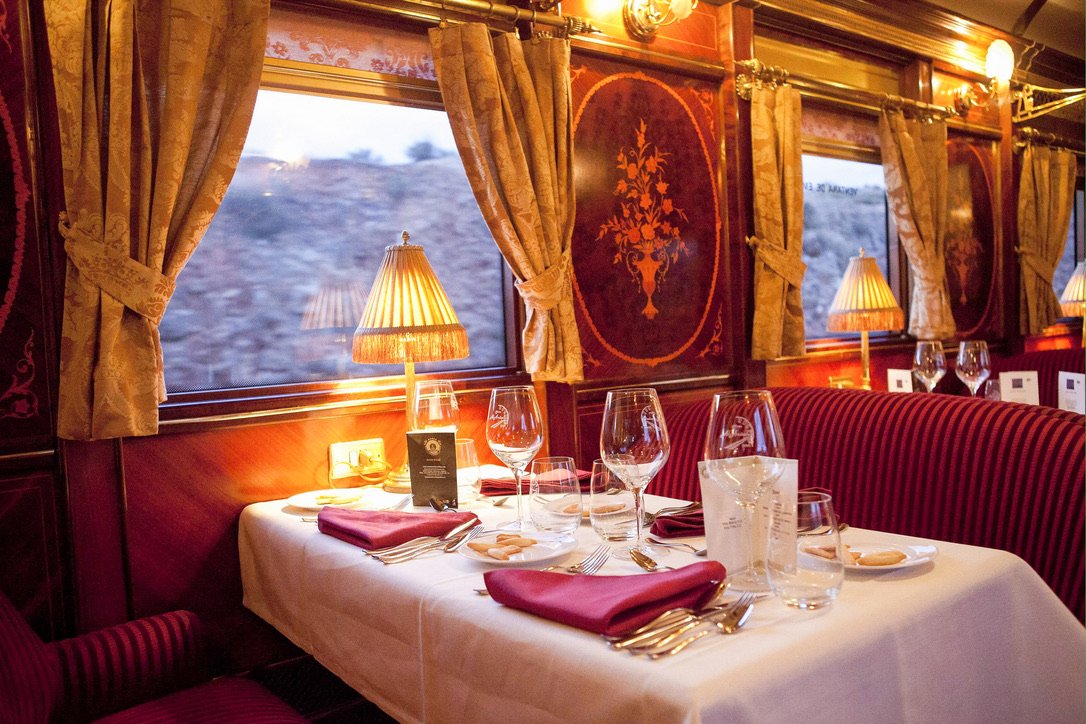 The restaurant car aboard the Al Ándalus luxury train, set for fine dining with regional Spanish cuisine.