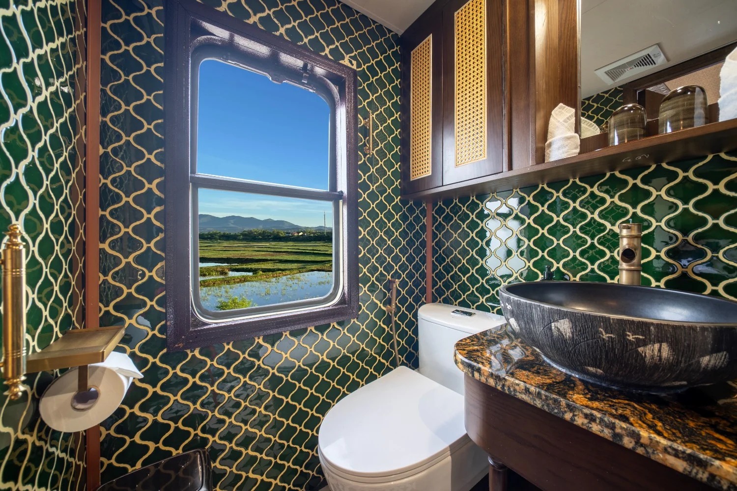 En-suite bathroom on board with emerald tiling and countryside view